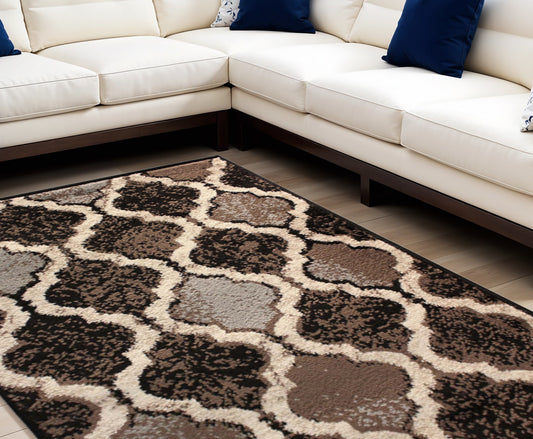 5' X 8' Brown Black And Ivory Quatrefoil Distressed Area Rug